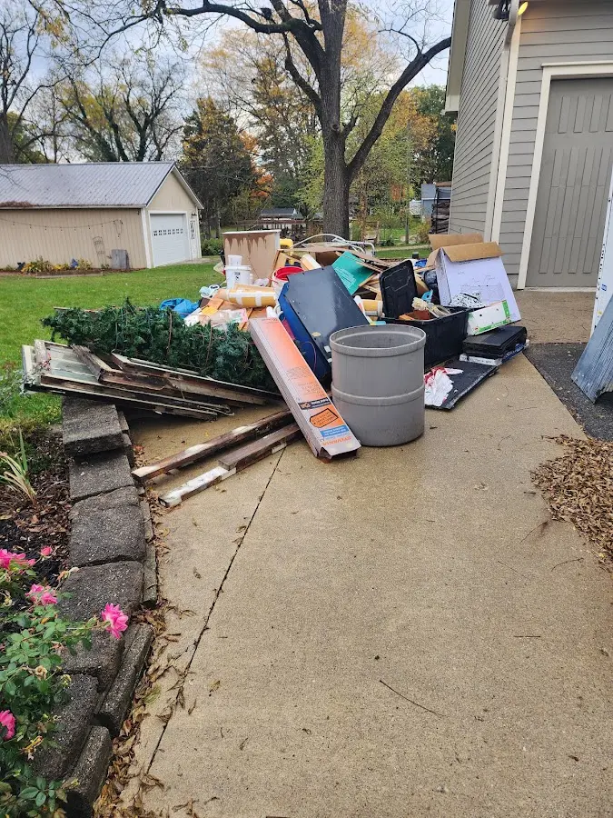 Dumpster being loaded with debris for Estate Cleanout Dumpster Rental in Plainview